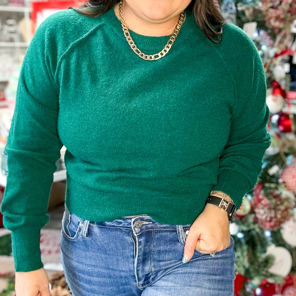 emerald green basic sweater with ribbed around the bottom edge and ribbed cuffed sleeves