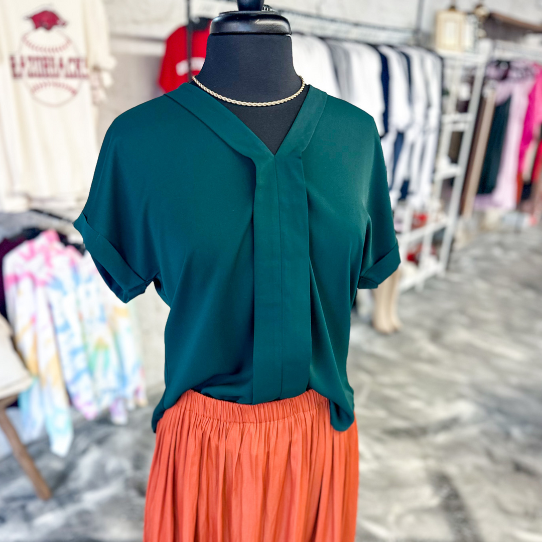 Luxury At Heart Emerald Green Top, emerald green women's top with a cuff detail on the sleeves and around the v-neck neckline down the front middle. 