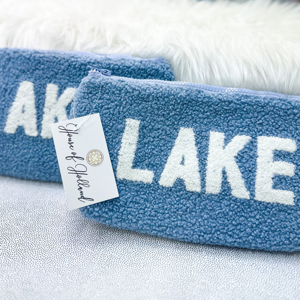 blue sherpa zipper pouch bag, with the word lake across the front in white.