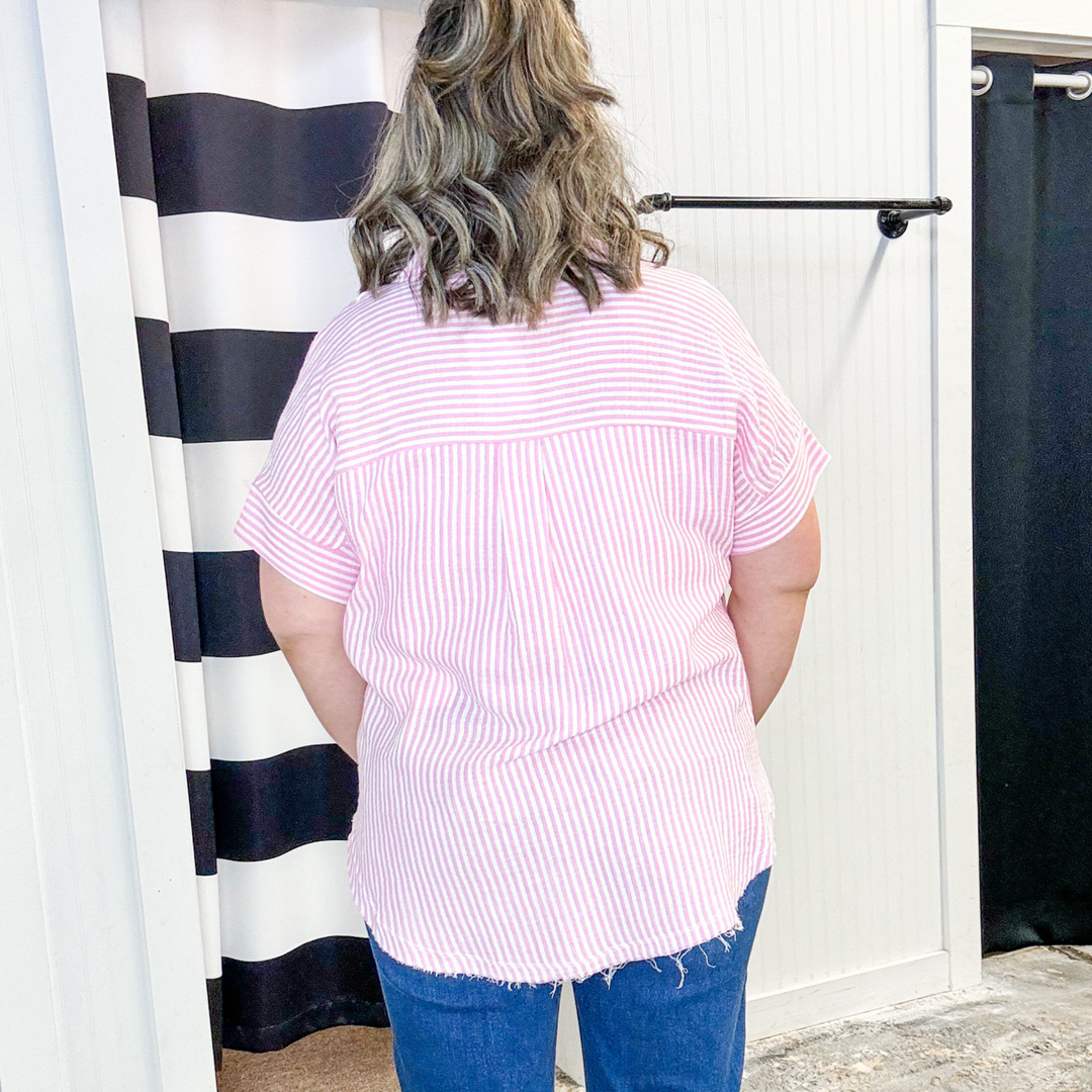pink and white seer sucker shirt, raw hem edge, v-neck, collar detail. 