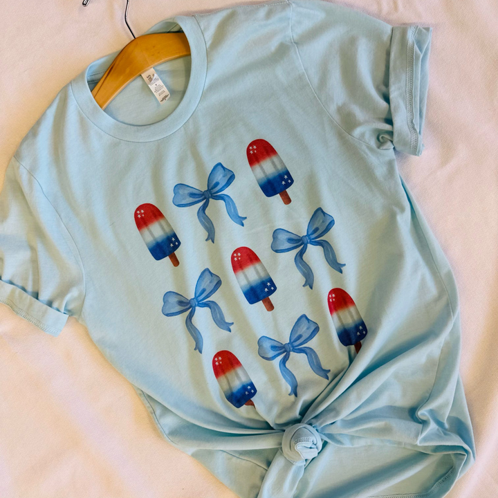 4th of july t shirts, light blue shirt with bomb pops and blue bows all over the front 