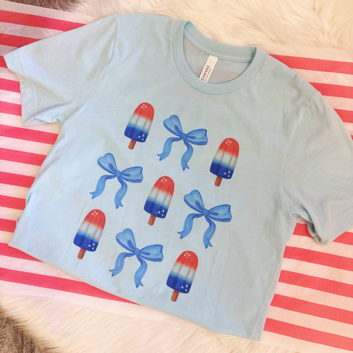 4th of july t shirts, light blue shirt with bomb pops and blue bows all over the front 