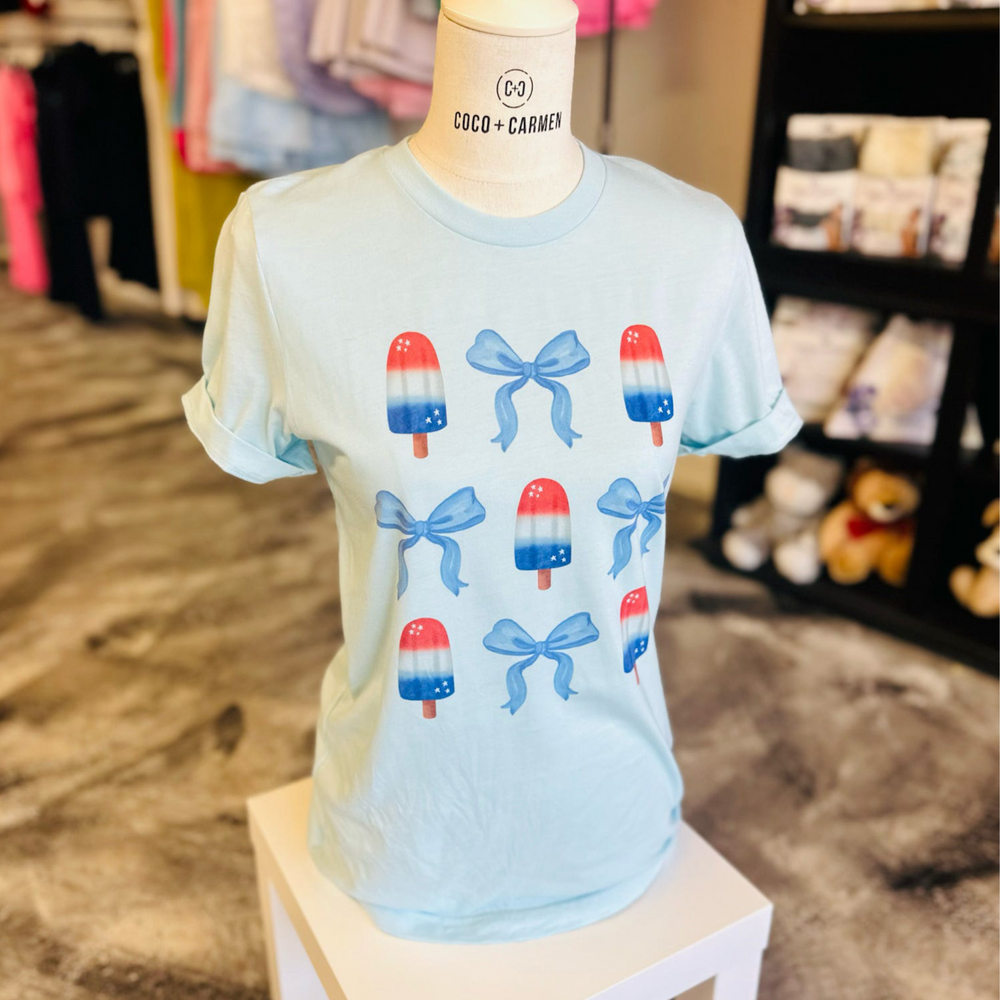 4th of july t shirts, light blue shirt with bomb pops and blue bows all over the front 