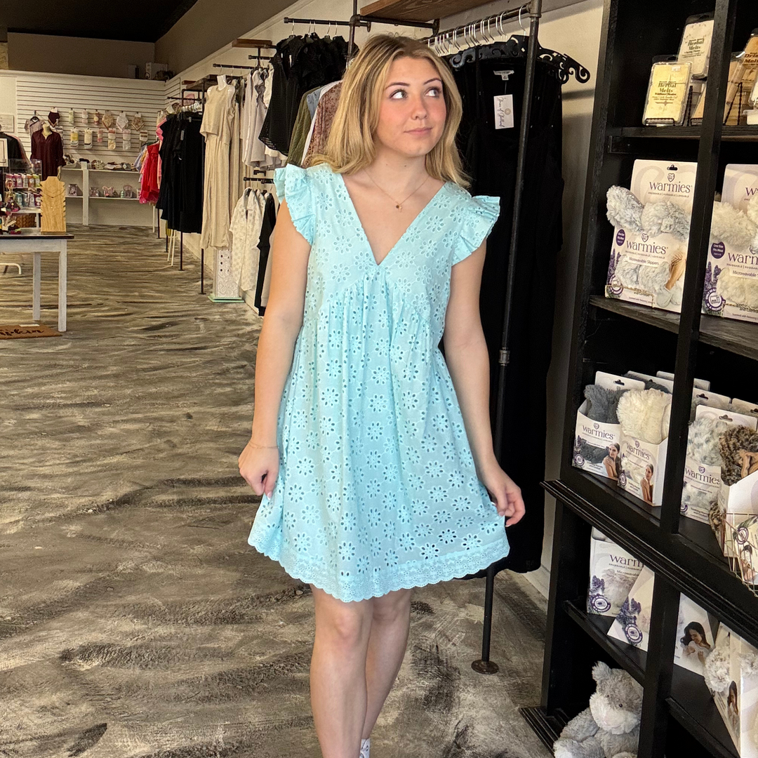 sky blue eyelet dress with v-neck front and back and a behind the neck tie strap.