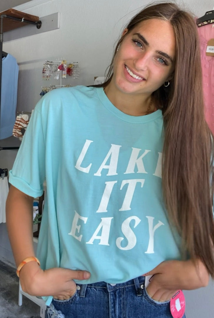 lake it easy graphic cropped tee, light blue color with white block font stating lake it easy.