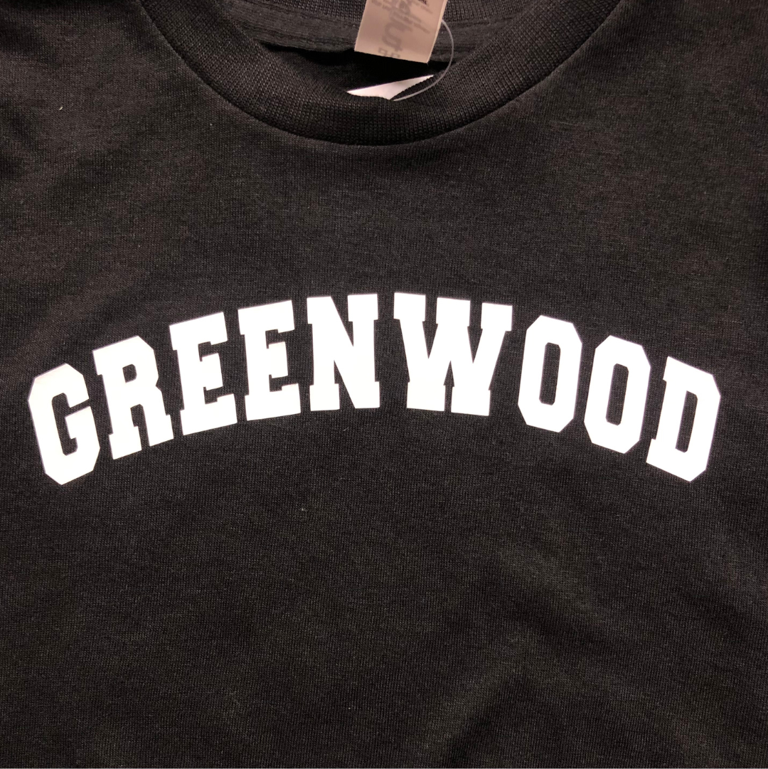 black tee that says Greenwood in white.
