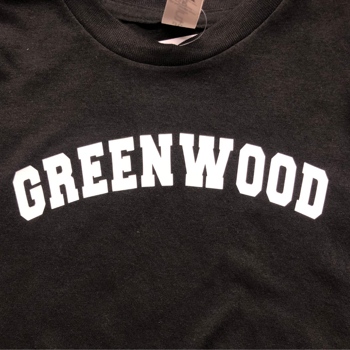 black tee that says Greenwood in white.