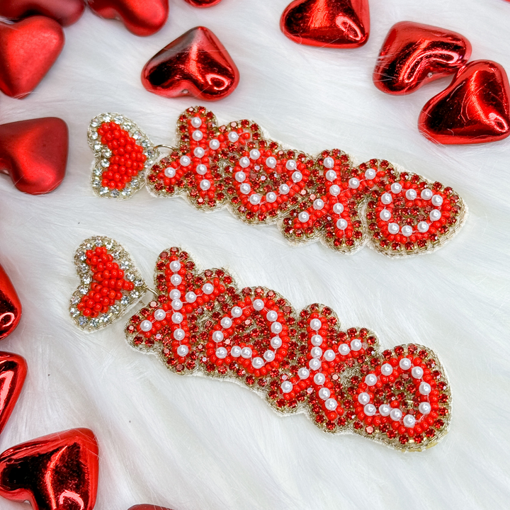 valentine's day beaded earrings. small red heart with red xo xo following in a downward direction, red letters have a small white beaded detail and outlined in gold