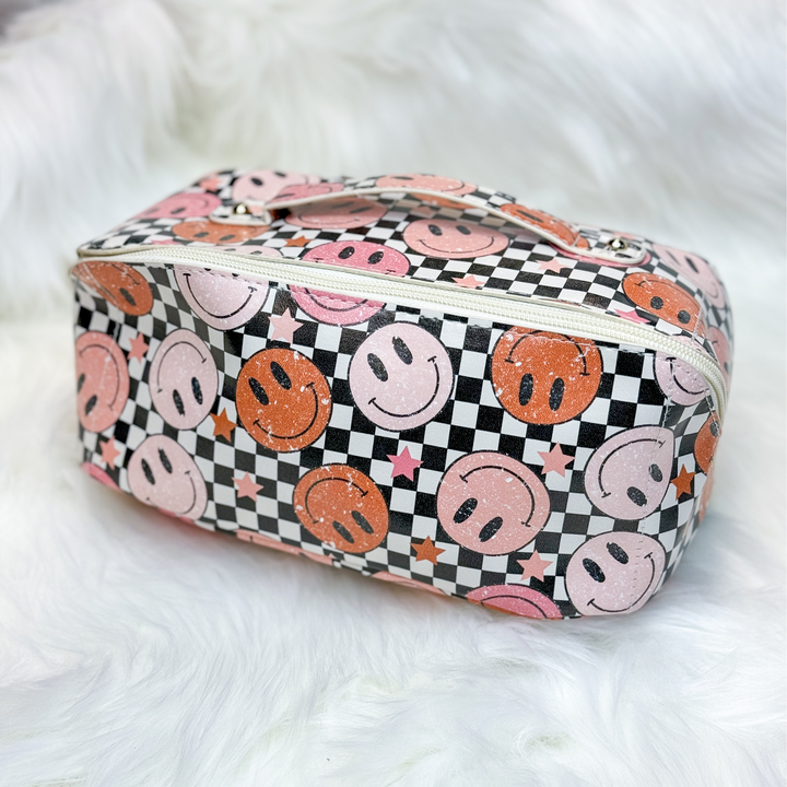 expandable multi-functional makeup bag with checkered background and many red and pink smiley faces