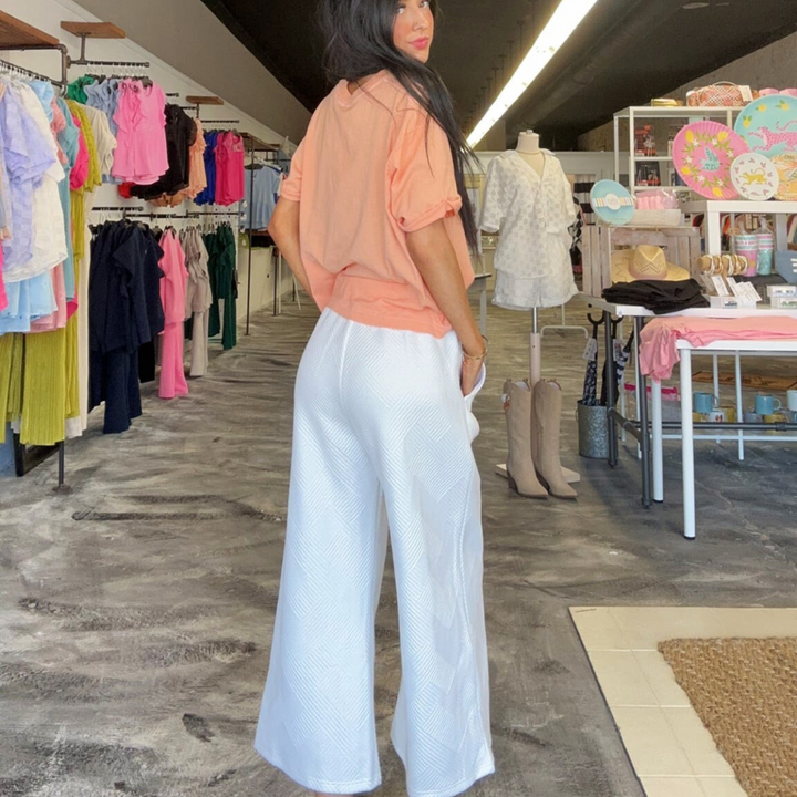 White textured flare pants, with drawstring.