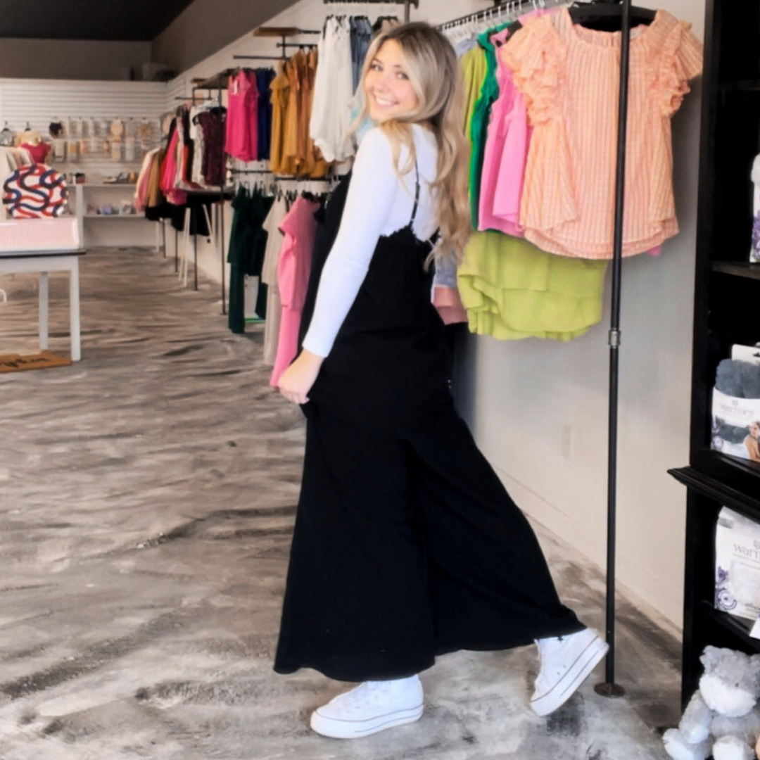 Unleash your inner fashionista with the Sunlit Days Wide Leg Black Jumpsuit! This trendy piece features a wide leg design, making it both stylish and comfortable.