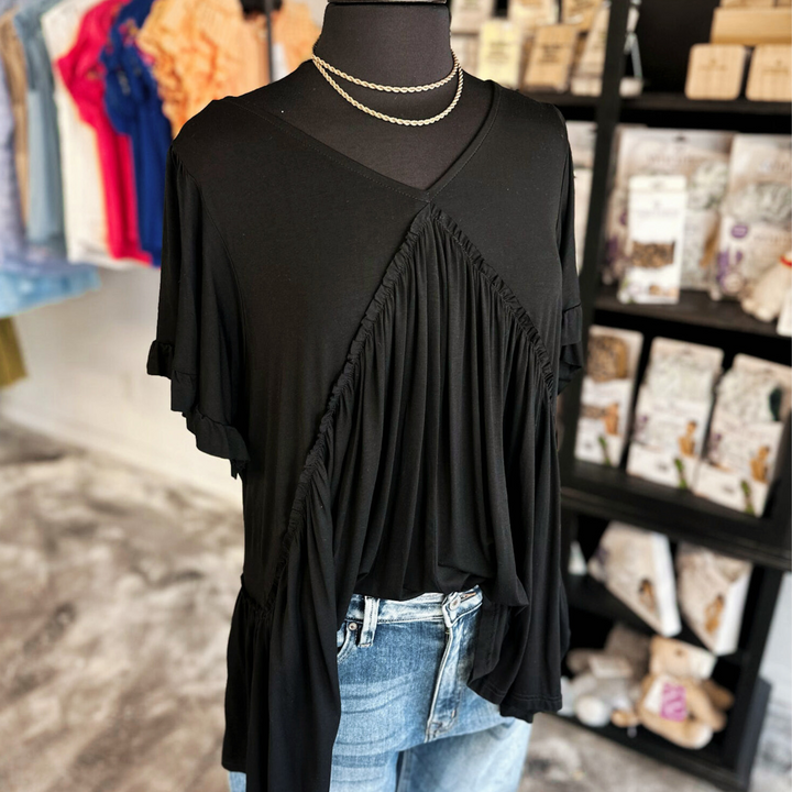 Black short sleeve top with bell sleeves ruffle detail.