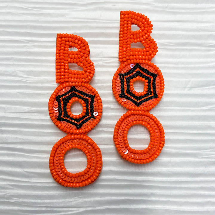halloween beaded earrings, Boo vertical in orange, middle O with a black spider web design in the O. 