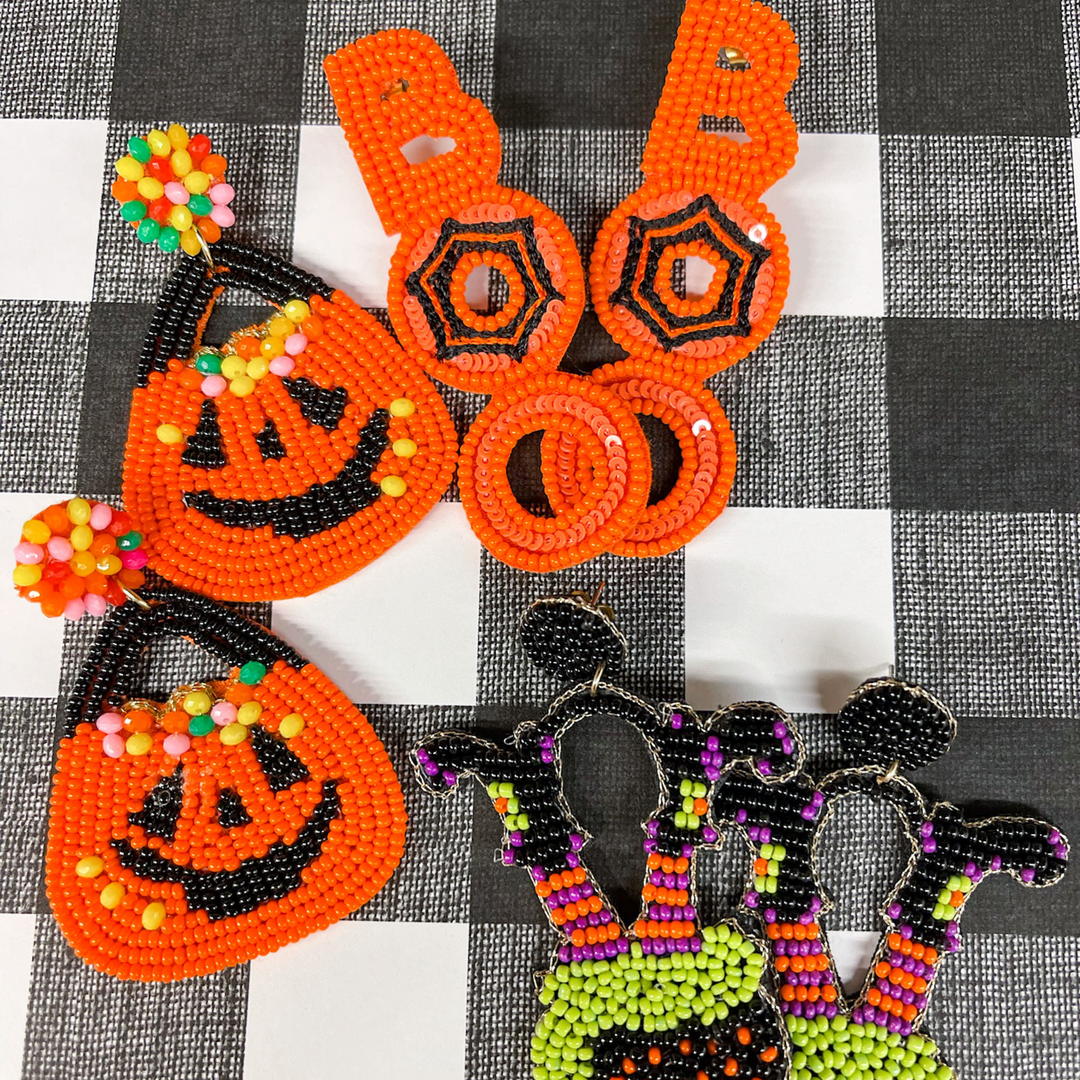 halloween beaded earrings, Boo vertical in orange, middle O with a black spider web design in the O. 