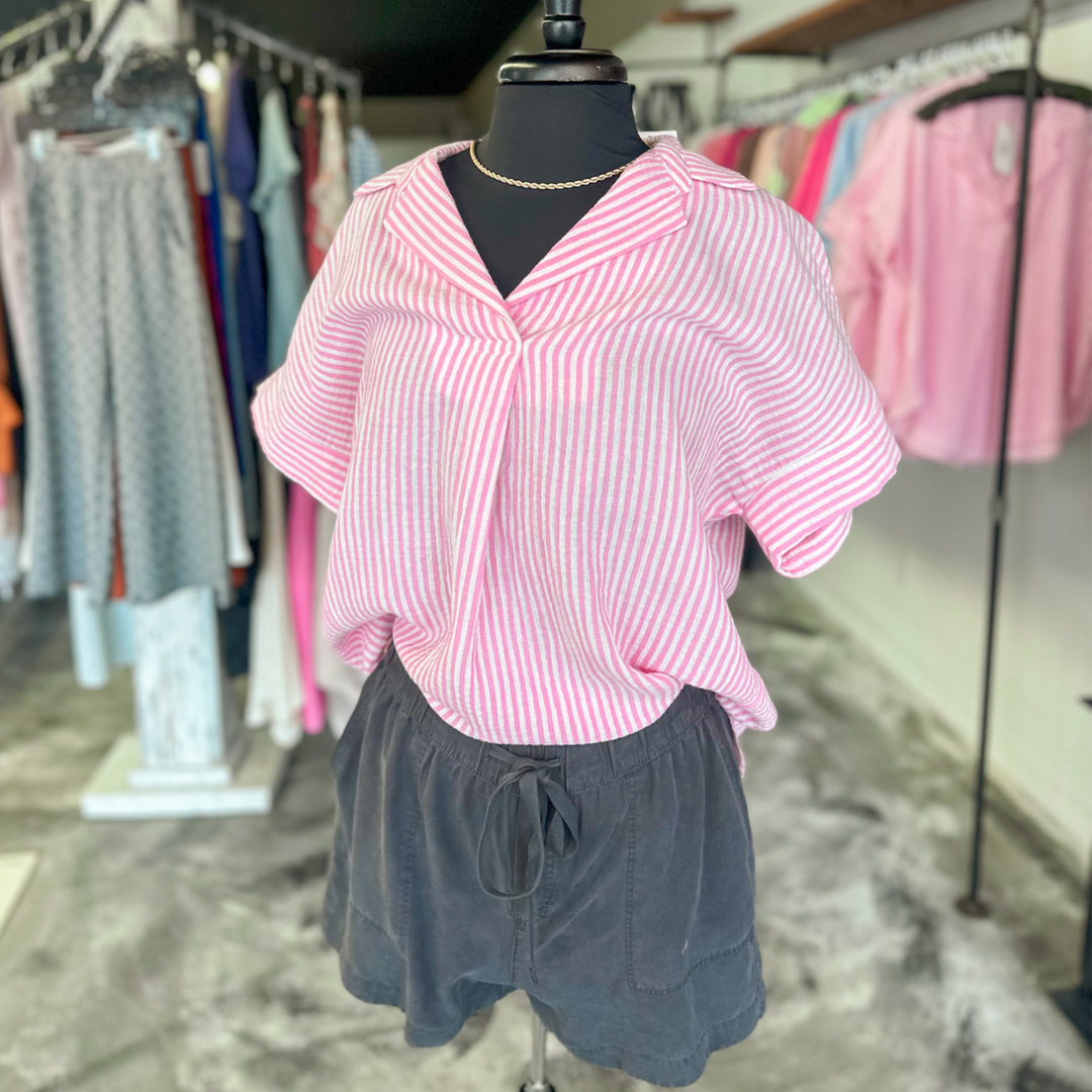 charcoal colored tilley shorts, super soft fabric, functioning pockets and jaw string, relaxed fit. pin stripe pink and white polo, v-neck top made out of gauze type fabric, cuffed sleeves and pleated front. 