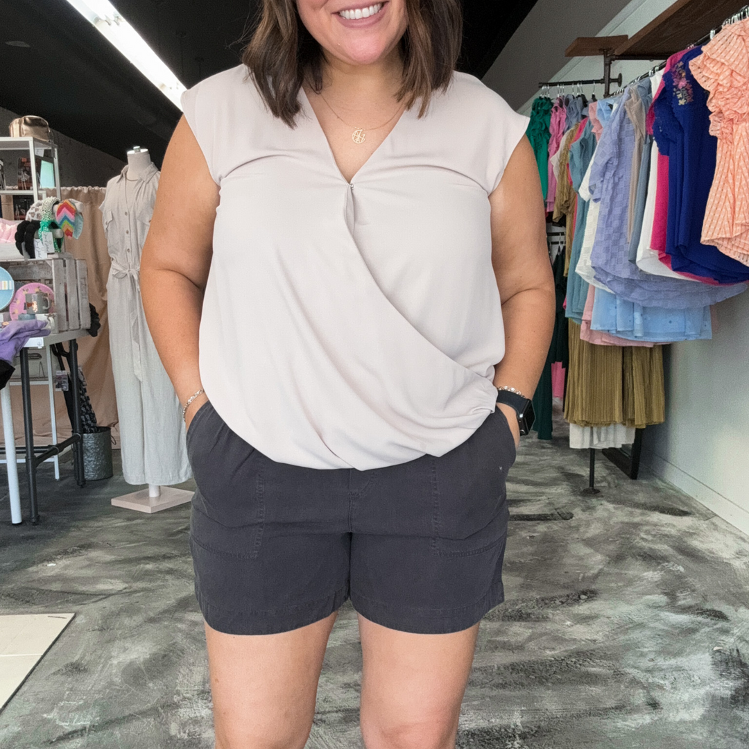 charcoal colored tilley shorts, super soft fabric, functioning pockets and jaw string, relaxed fit. pin stripe pink and white polo, v-neck top made out of gauze type fabric, cuffed sleeves and pleated front.