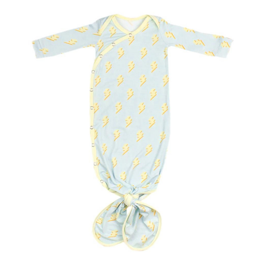 copper pearl knotted baby gown, bolt print, light blue background with 3d lightening bolts in yellow, yellow trim, snap button, knotted at the bottom so it can grow with baby. 