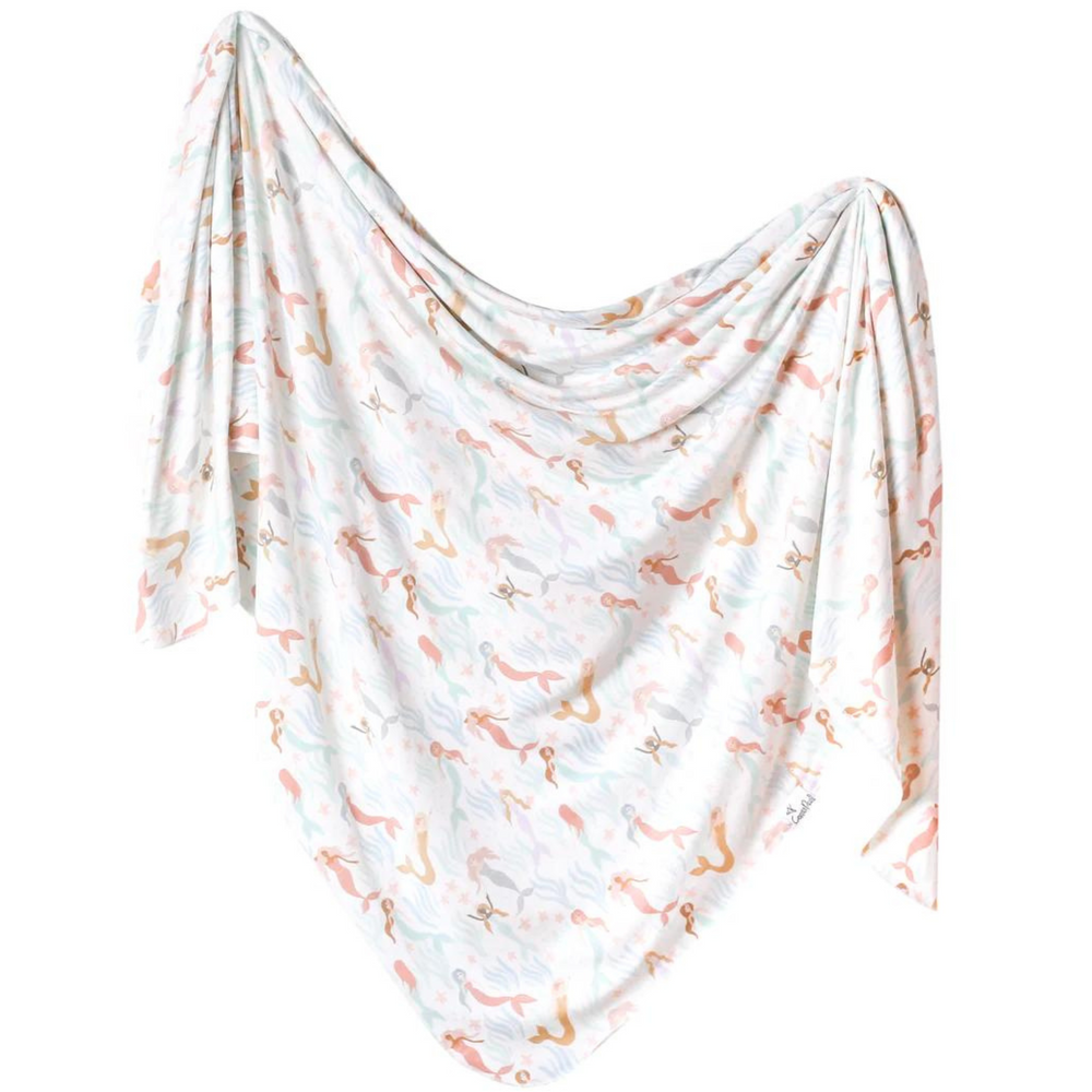 copper pearl coral swaddle which is muted tones of pastel colors of mermaids