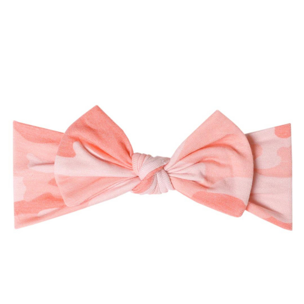copper pearl remi knit headband bow. multiple pink colors making a camo print. 