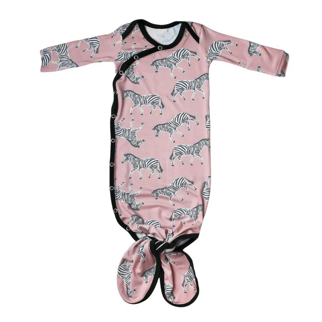 copper pearl knotted baby gown, zella print, pink background with zebras all over, black trim, snap button, knotted at the bottom so it can grow with baby. 
