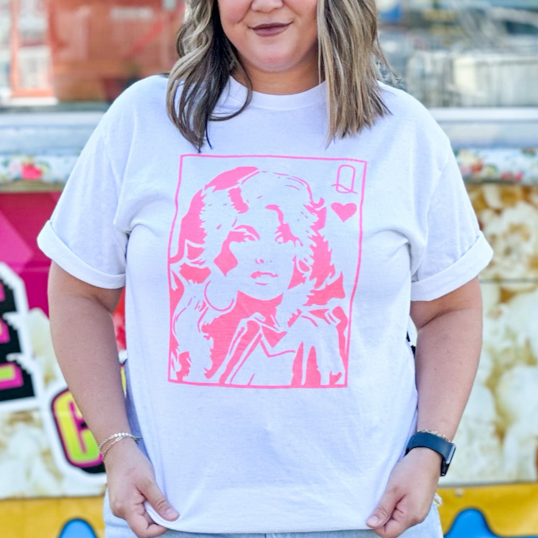 Dolly Parton queen of hearts graphic tee. Design is pink on a white tee shirt. 