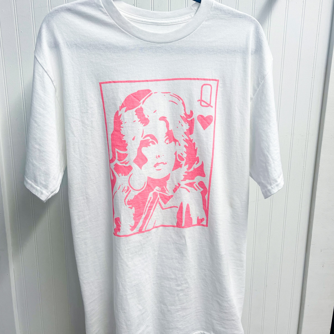 Dolly Parton queen of hearts graphic tee. Design is pink on a white tee shirt. 