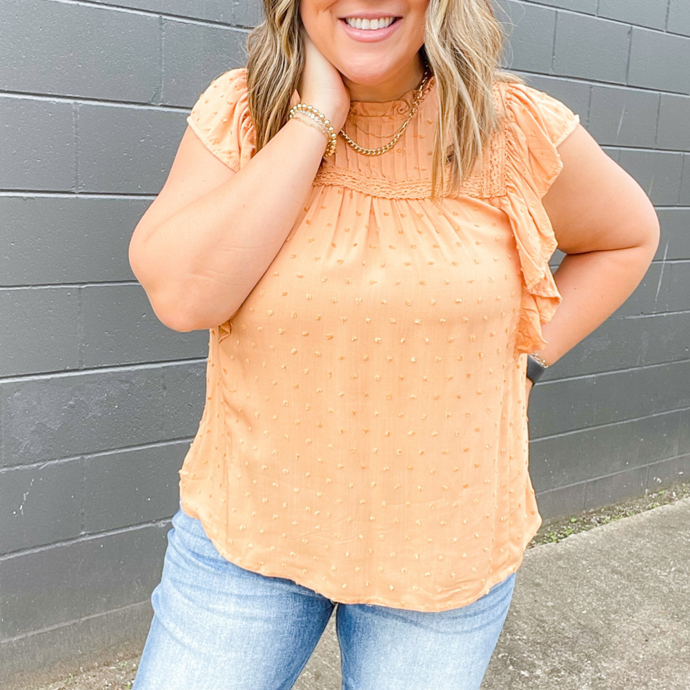 Serene Dreams Dusty Orange Top, sweet dusty orange top with small swiss dot detail, neckline ruffles, pleated type sleeves and other neckline details with trimmed fabric detail.