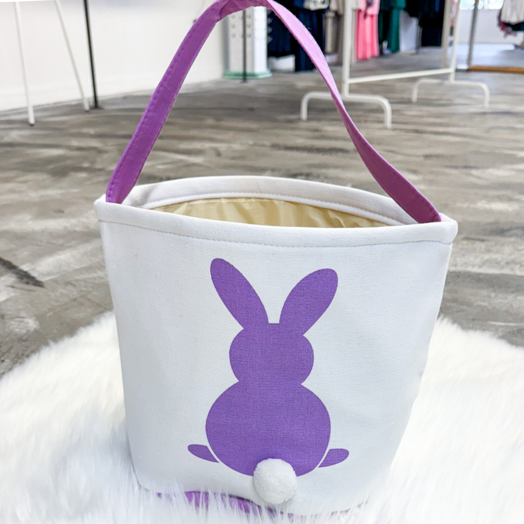 easter basket, white canvas with purple handle and purple bunny outline on the front with a cotton tail, able to be monogrammed. 