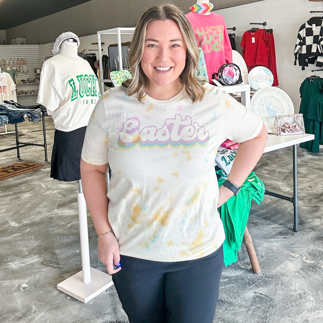 easter tee, watercolor tie dye tee shirt, easter in a bubble cursive font in lavender, blue and yellow. 