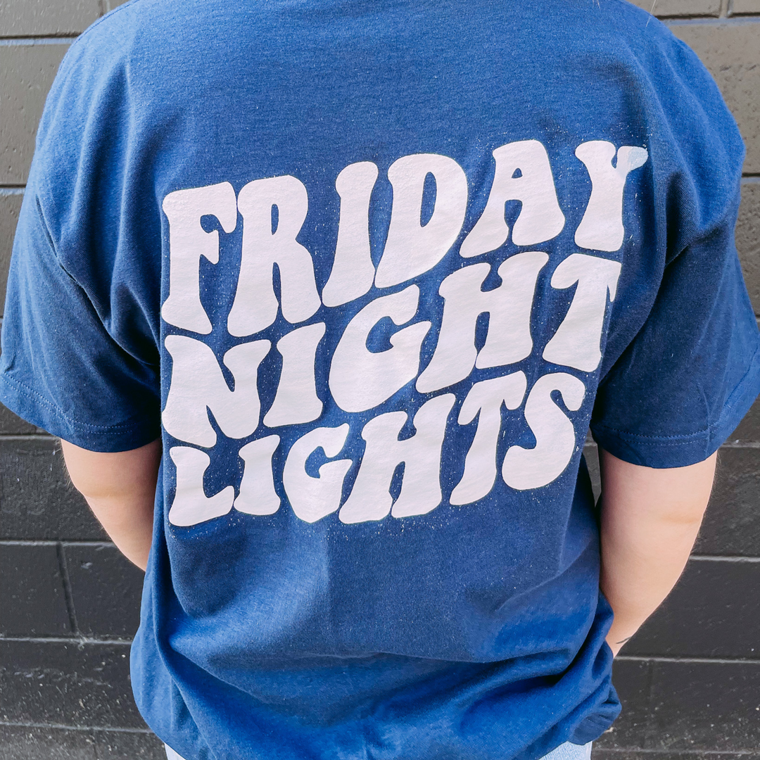 navy blue game day tee shirt with a greenwood football helmet on front chest and friday night lights in cute font on back