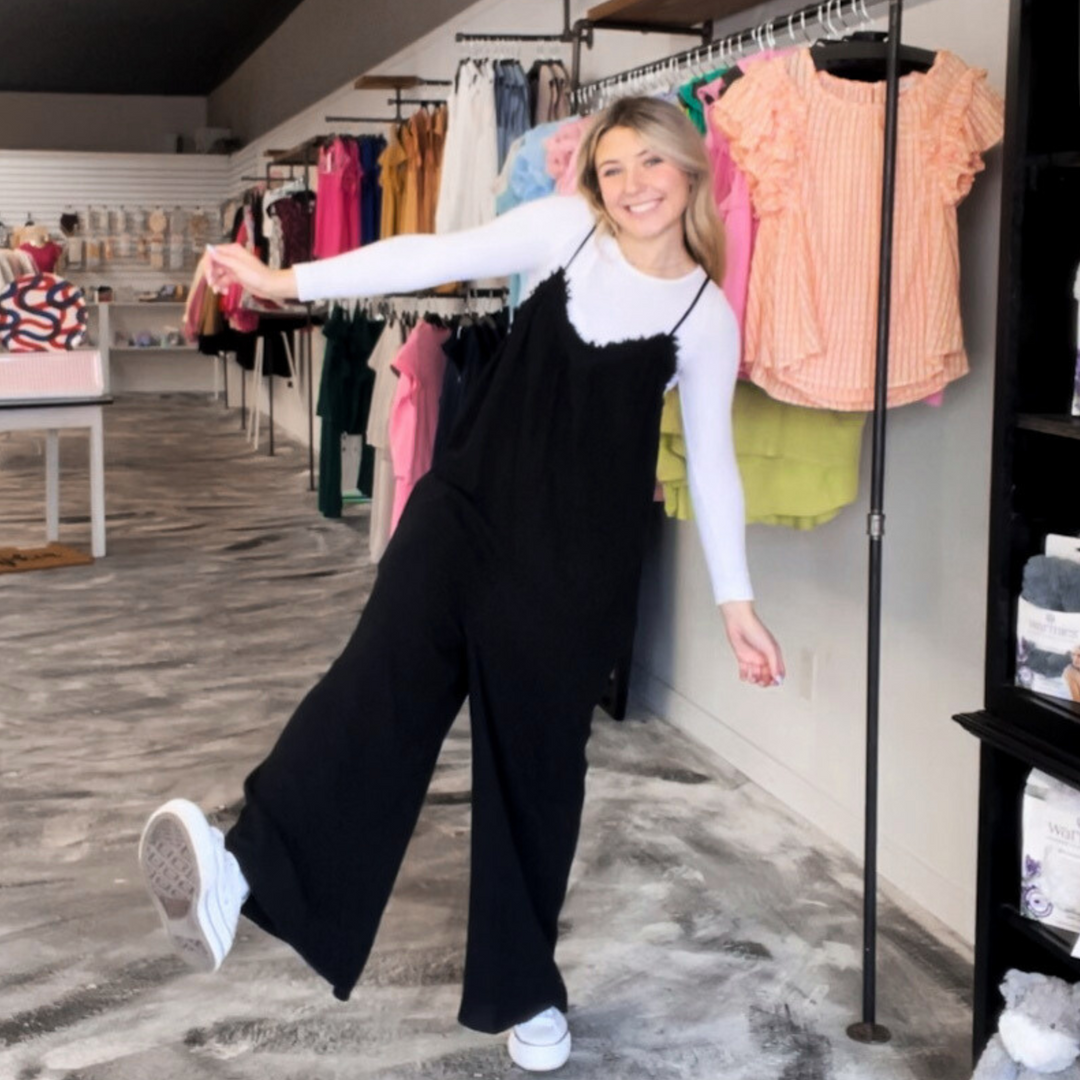 Unleash your inner fashionista with the Sunlit Days Wide Leg Black Jumpsuit! This trendy piece features a wide leg design, making it both stylish and comfortable.