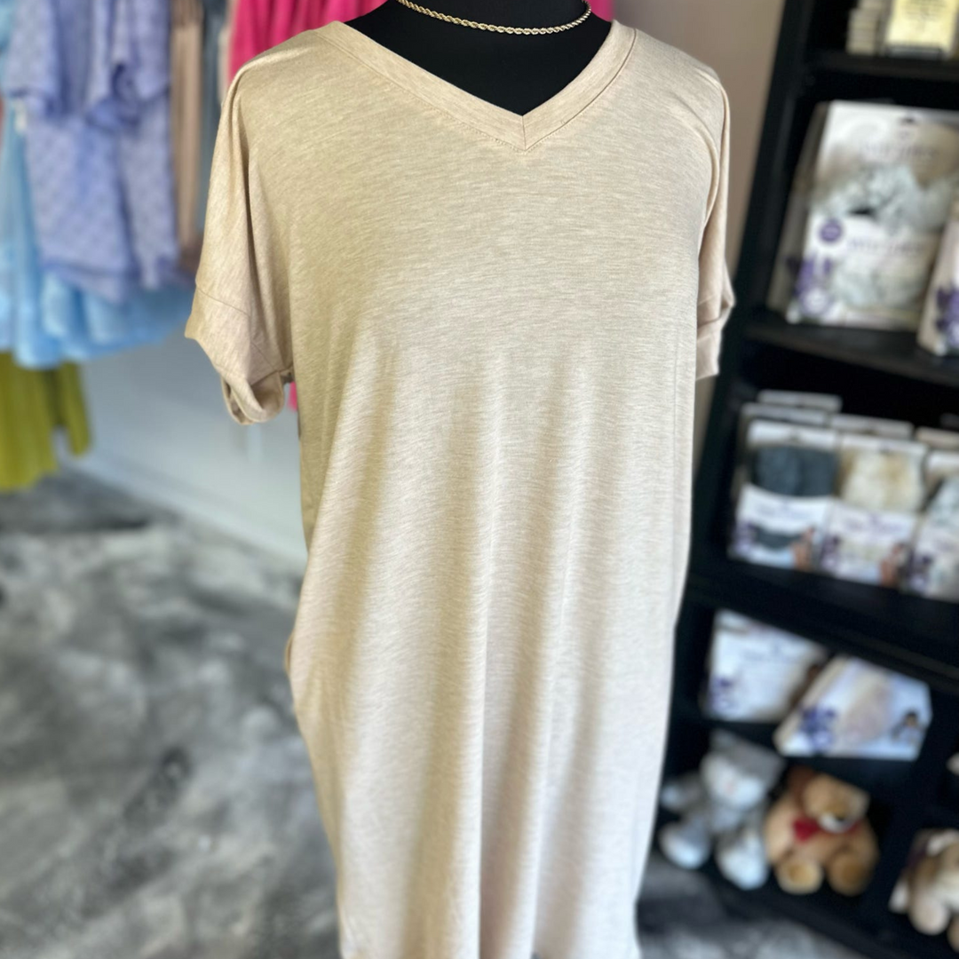 tan, cream colored t-shirt dress, functioning pockets on the side, soft comfy fabric, cuffed sleeves and a slight v-neck line