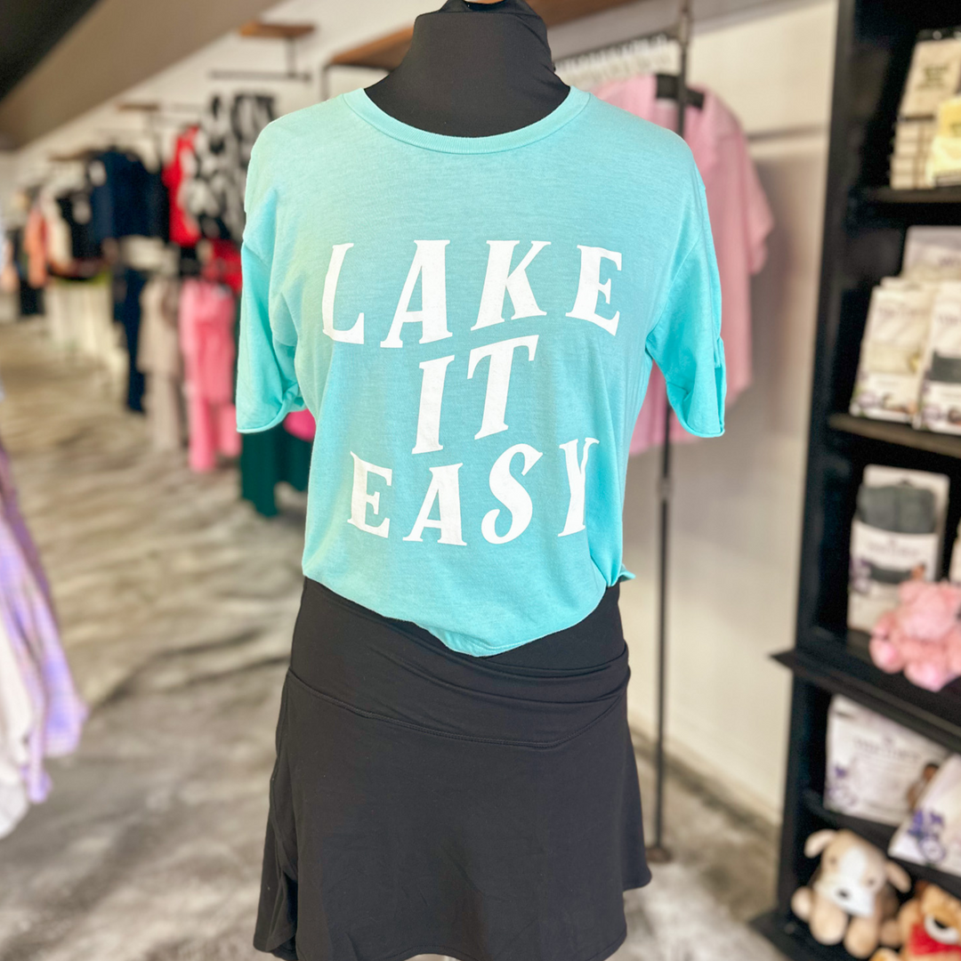 lake it easy graphic cropped tee, light blue color with white block font stating lake it easy.