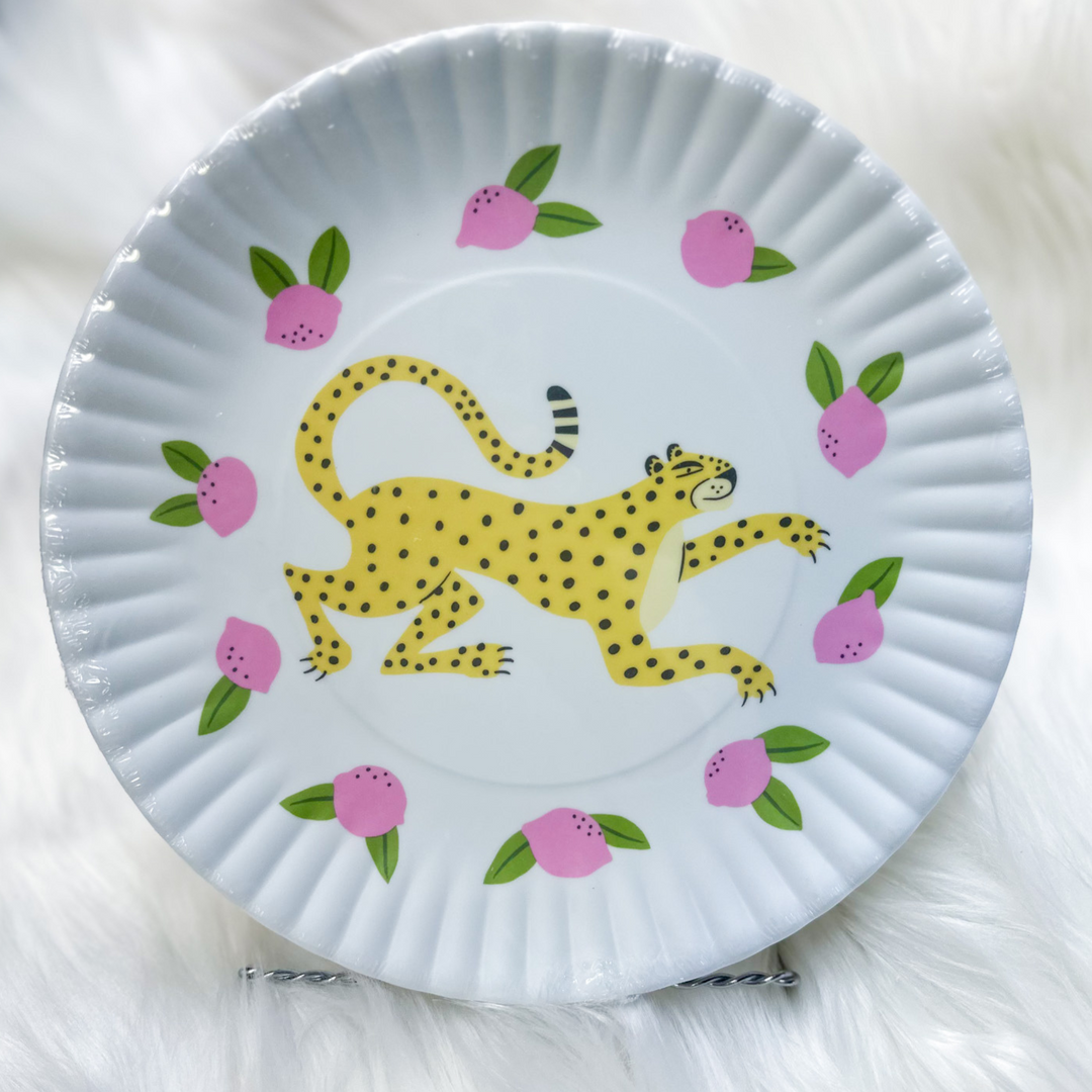 Fun plates, bright pink, white, light blue, dark blue, yellow leopard on all, little berries and greenery around leopard