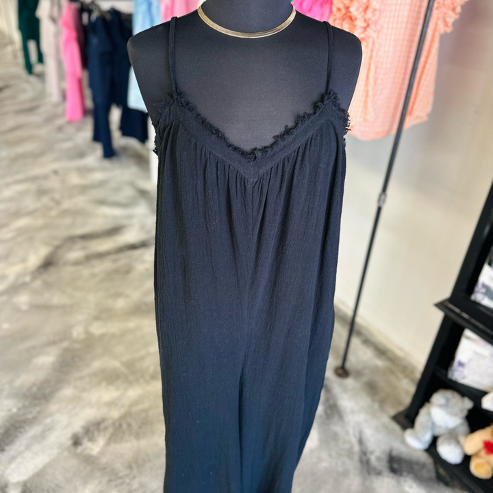 Unleash your inner fashionista with the Sunlit Days Wide Leg Black Jumpsuit! This trendy piece features a wide leg design, making it both stylish and comfortable.