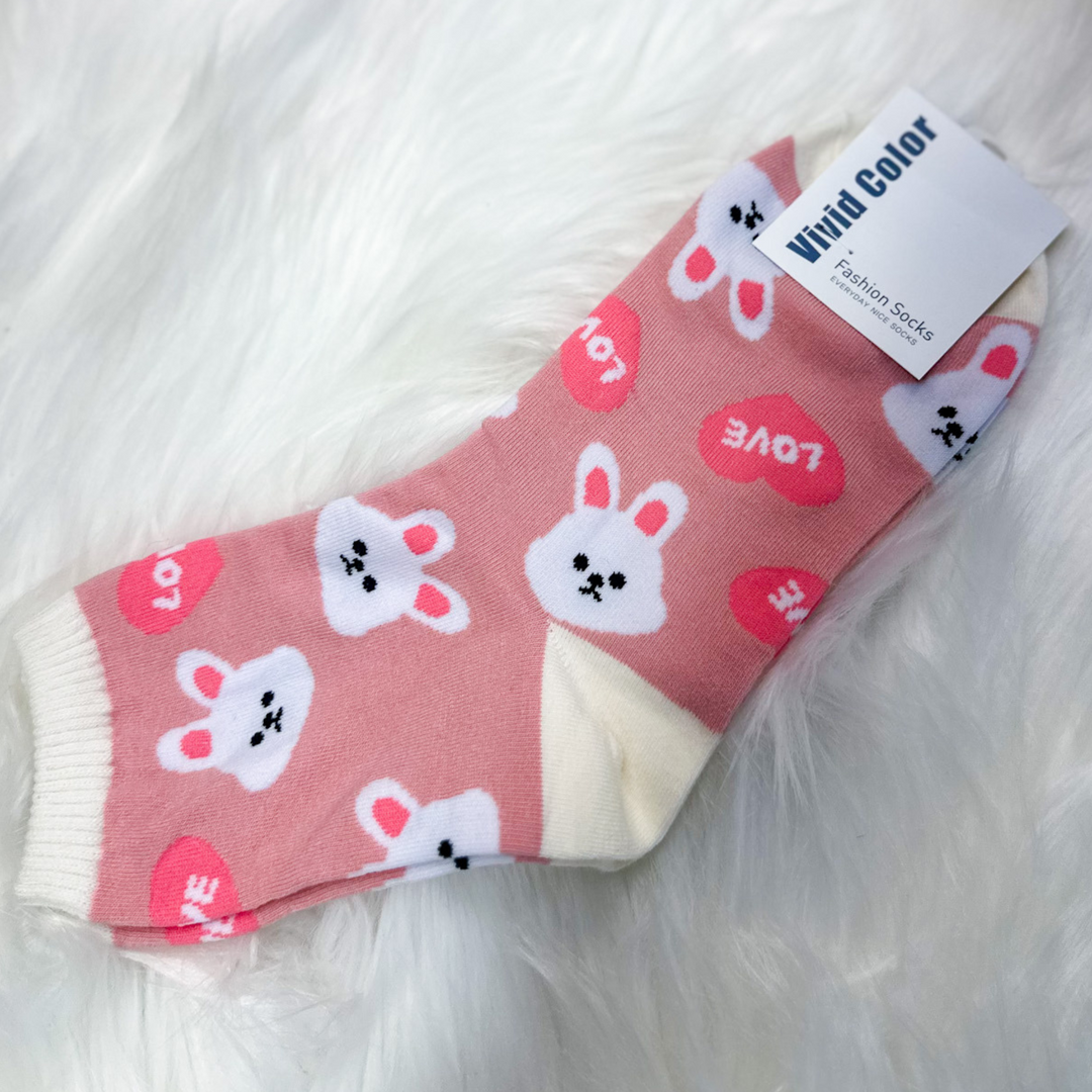 pink and cream socks with white bunny faces and pink hearts that say love