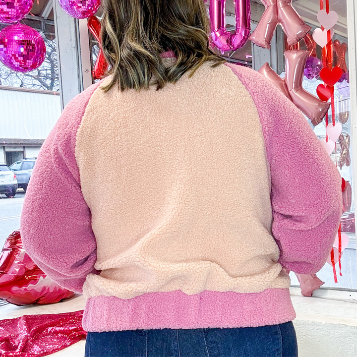 fleece bomber jacket with snap button front, elastic waist band, pink and cream sherpa fleece. 