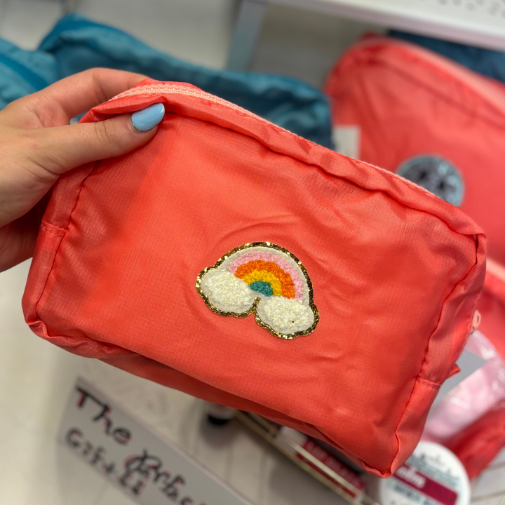 Rainbow patch coral makeup bag with light pink zipper.