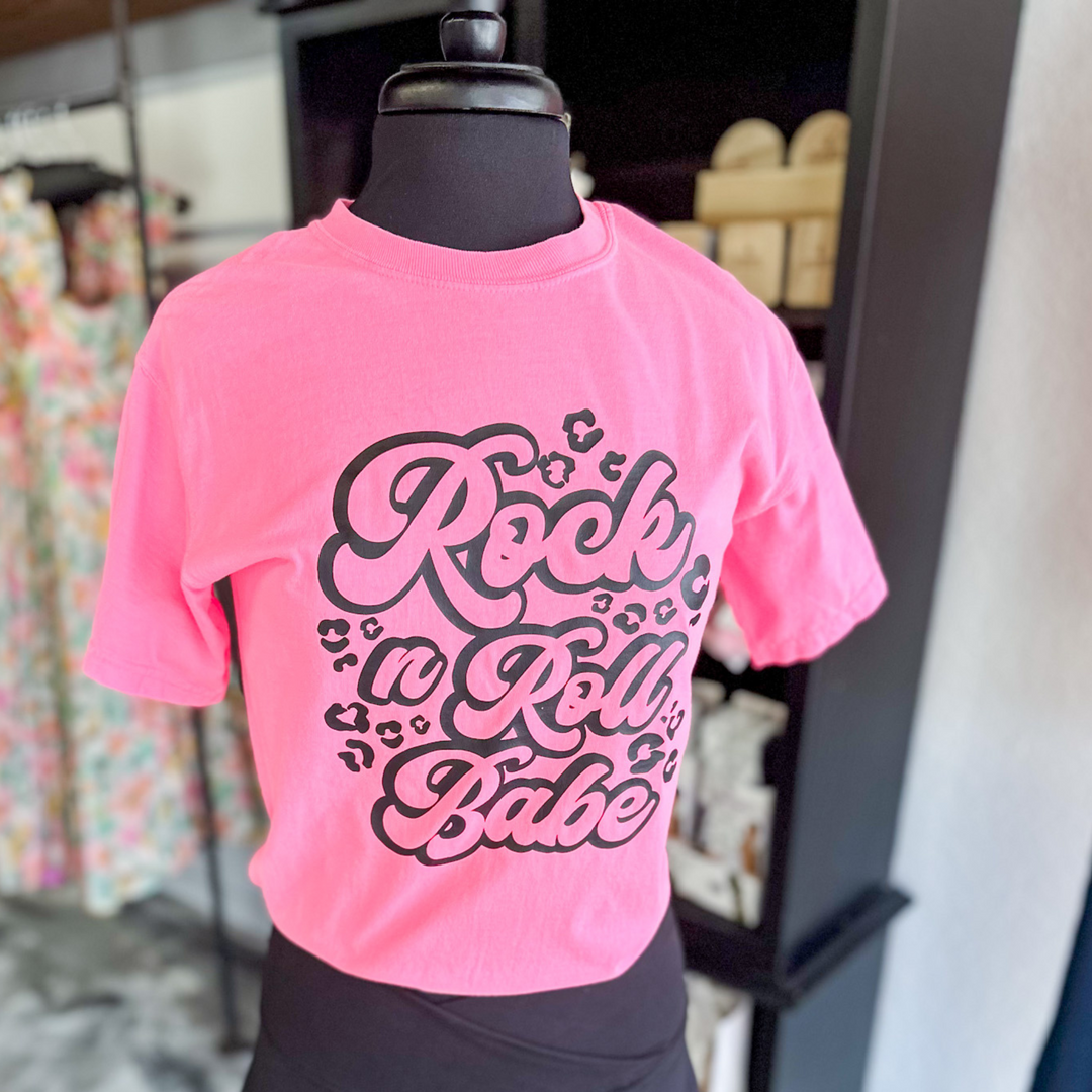 neon pink short sleeve, says Rock n Roll babe in black with black leopard around words