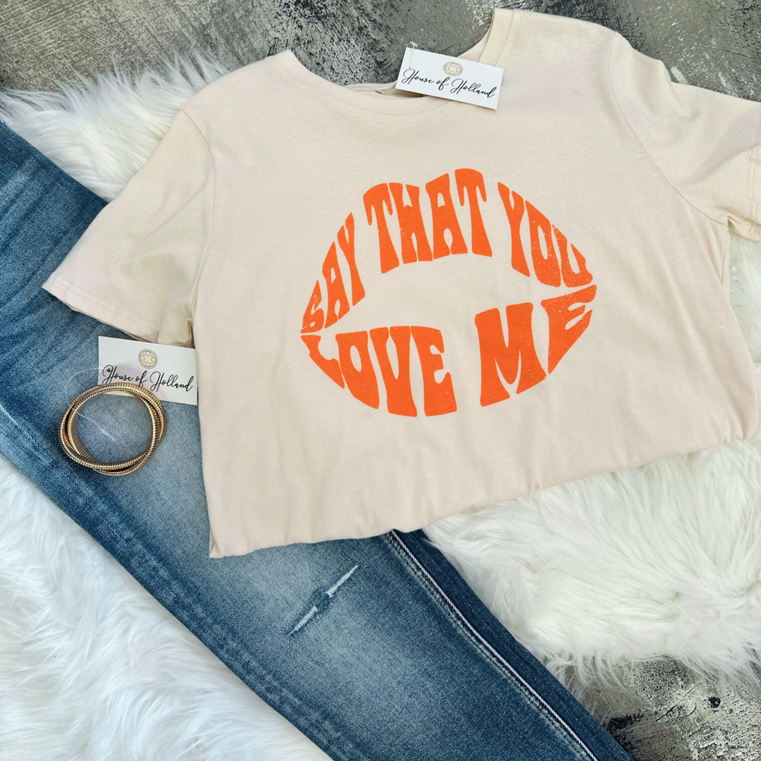 say that you love me top, writing in pinkish orange, light pink top.