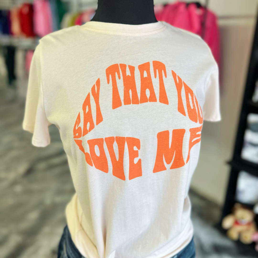 say that you love me top, writing in pinkish orange, light pink top.