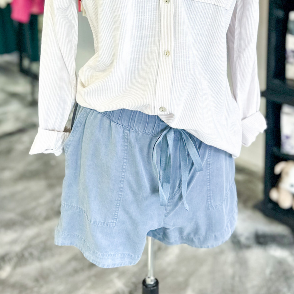 slate blue colored tilley shorts, super soft fabric, functioning pockets and jaw string, relaxed fit. very thin pin striped button up shirt in an oatmeal and cream color. 