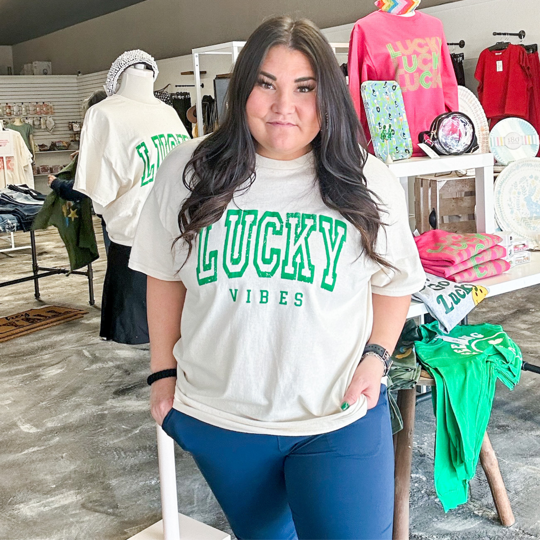 St. Patrick's day tee, lucky vibes in green puff screen on a cream oversized tee. 