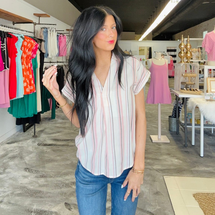 Real Fling Striped Woven Top! Featuring a vibrant mix of complementary stripes, plus a back button-down detail that's sure to be the cherry on top of your look.