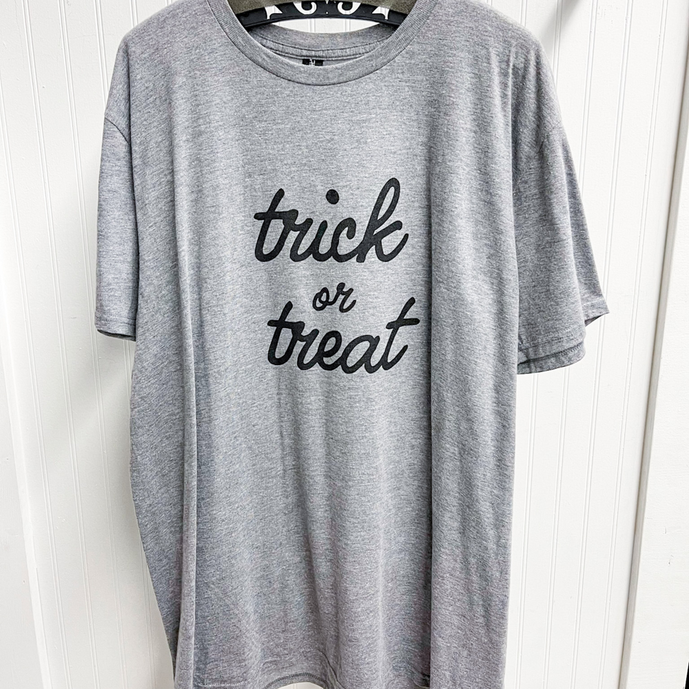 trick or treat halloween graphic tees, grey tee shirt with trick or trick in a cursive font on the front in black. 
