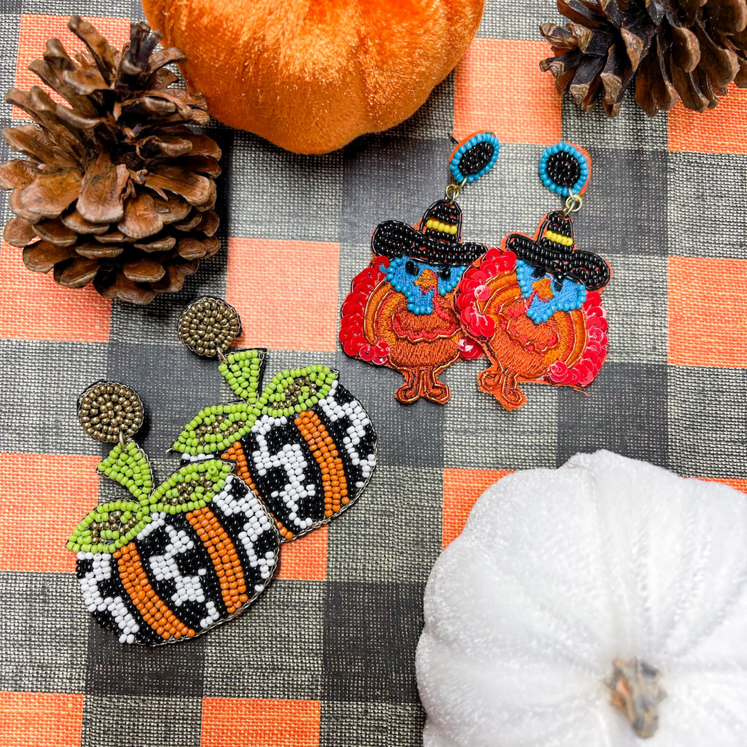 fall beaded earrings, turkeys wearing a pilgram hat. multi colors with black, yellow, red, blue, brown and orange. 