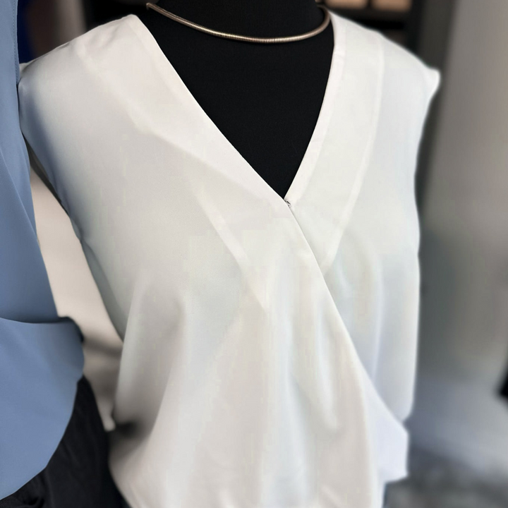 V-neck blouse with a wrap front detail, offered in khaki, light blue, and white.