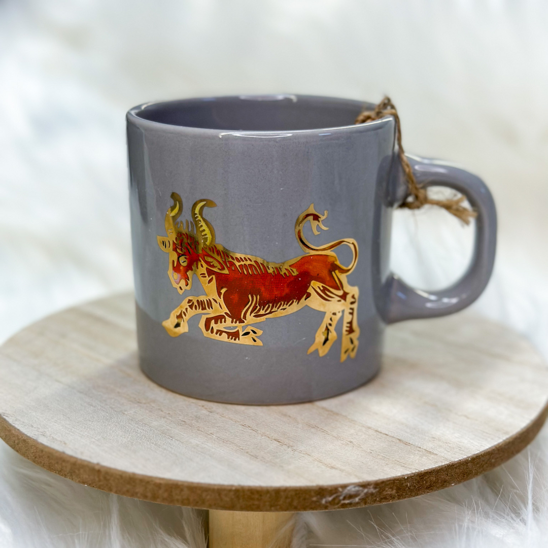 coffee cups, all 12 zodiac signs, different designs representing each zodiac sign, some animals, some vibrant colors on certain cups 