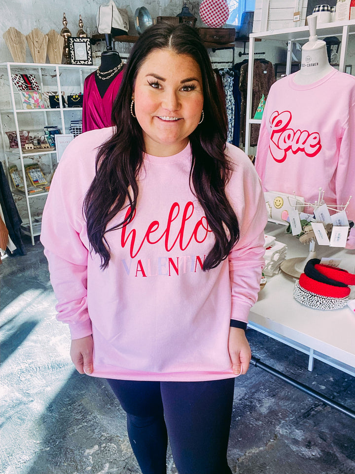 "hello valentine" valentine's day sweatshirt with hello in red script and valentine written in light purple, light pink and red block lettering 